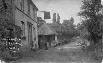 The Rising Sun Public House at Nutbourne, pictured in 1910. The elegant Victorian frontage remains unchanged to this day, albeit partly hidden behind green creeper which reinforces the old world charm.